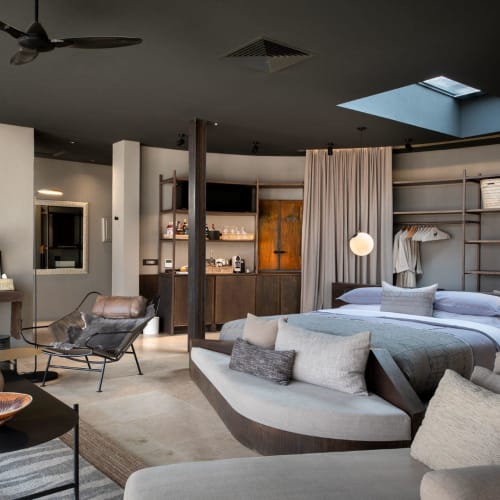 Luxurious and spacious interior suite at andBeyond Sossusvlei Desert Lodge with modern decor and cozy seating.