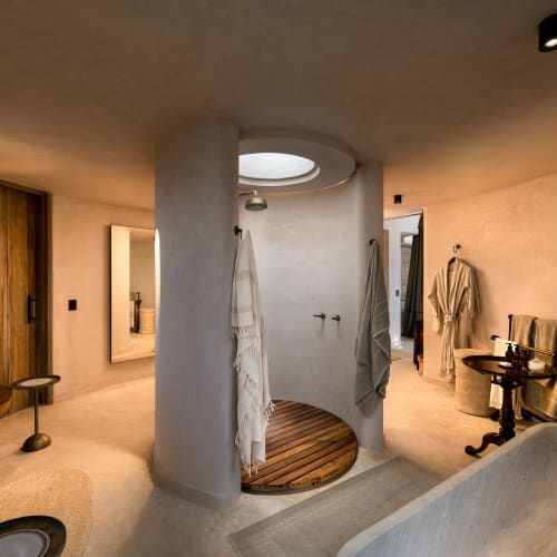 Luxurious bathroom with a circular shower area and elegant decor in a luxury lodge suite.