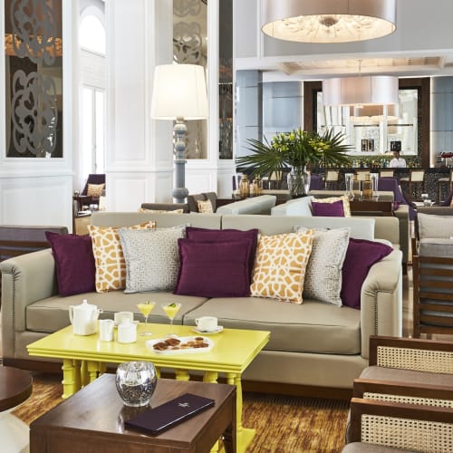 Luxusartige Hotellobby mit eleganten Möbeln, Kissen und stimmungsvoller Beleuchtung.