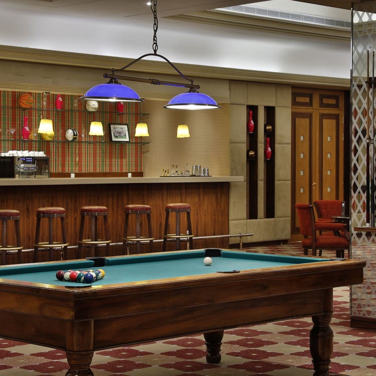 A billiard table in front of a bar