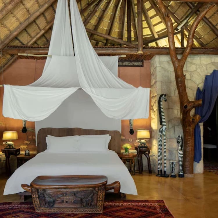 a bedroom with a thatched roof and a bed