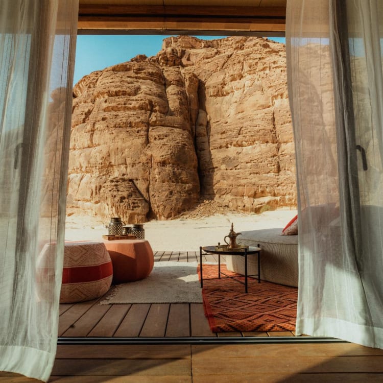 A view from the inside of the room overlooking parts of the desert and rock formations