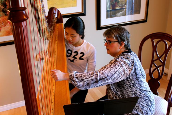 Harp Student Lauren tries the harp.