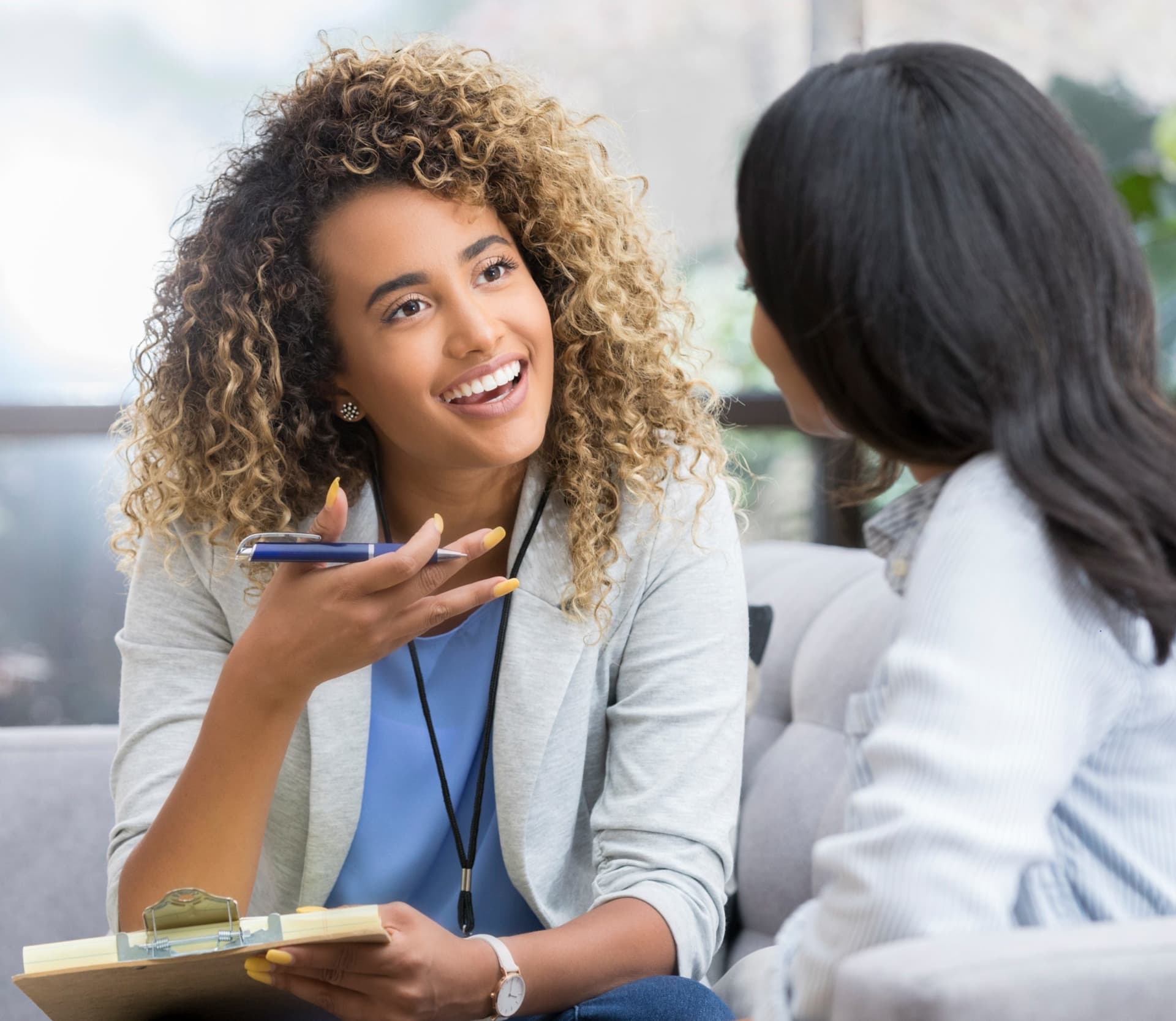 African American woman speaking to a colleague