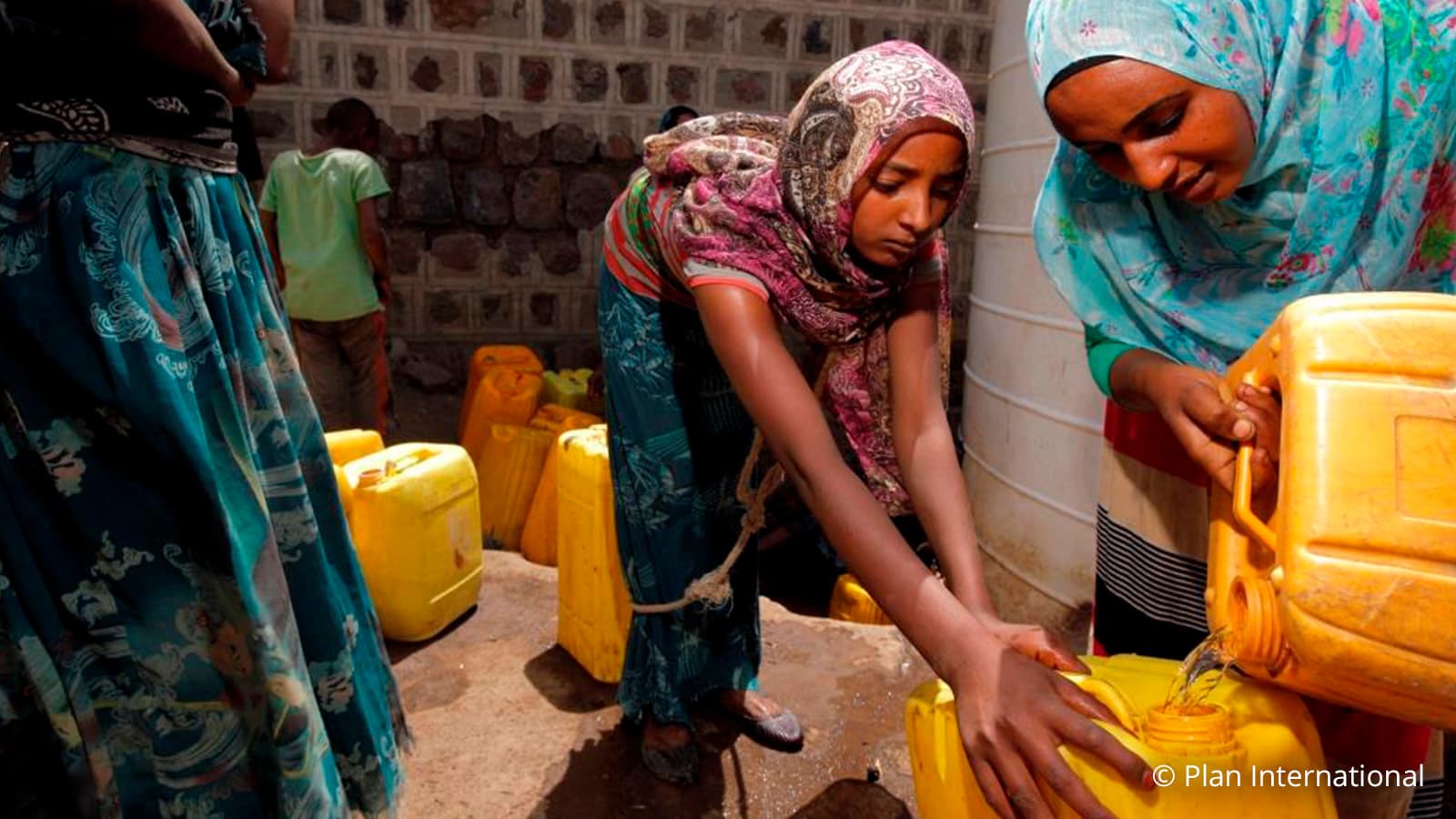 Woman filling water container 