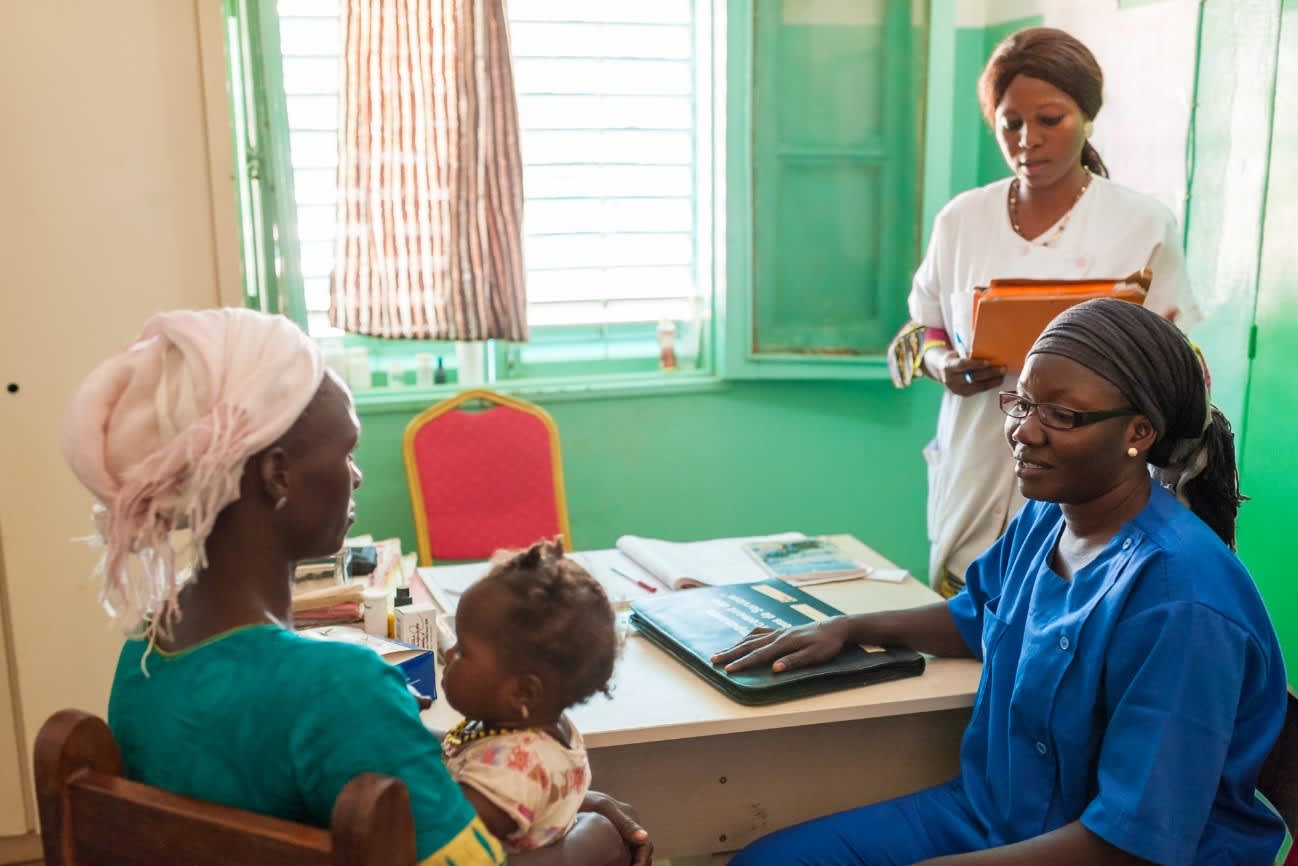 Physician talking with woman and child