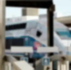 A modern, high-speed train engine waiting at a train station loading platform