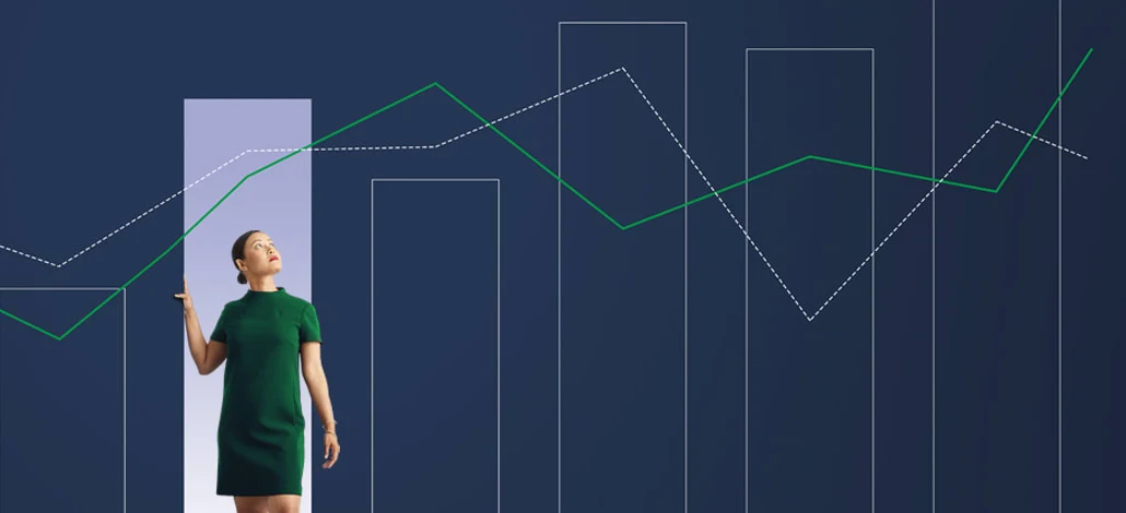 Image showing a woman standing inside a bar chart looking at line graphs above her