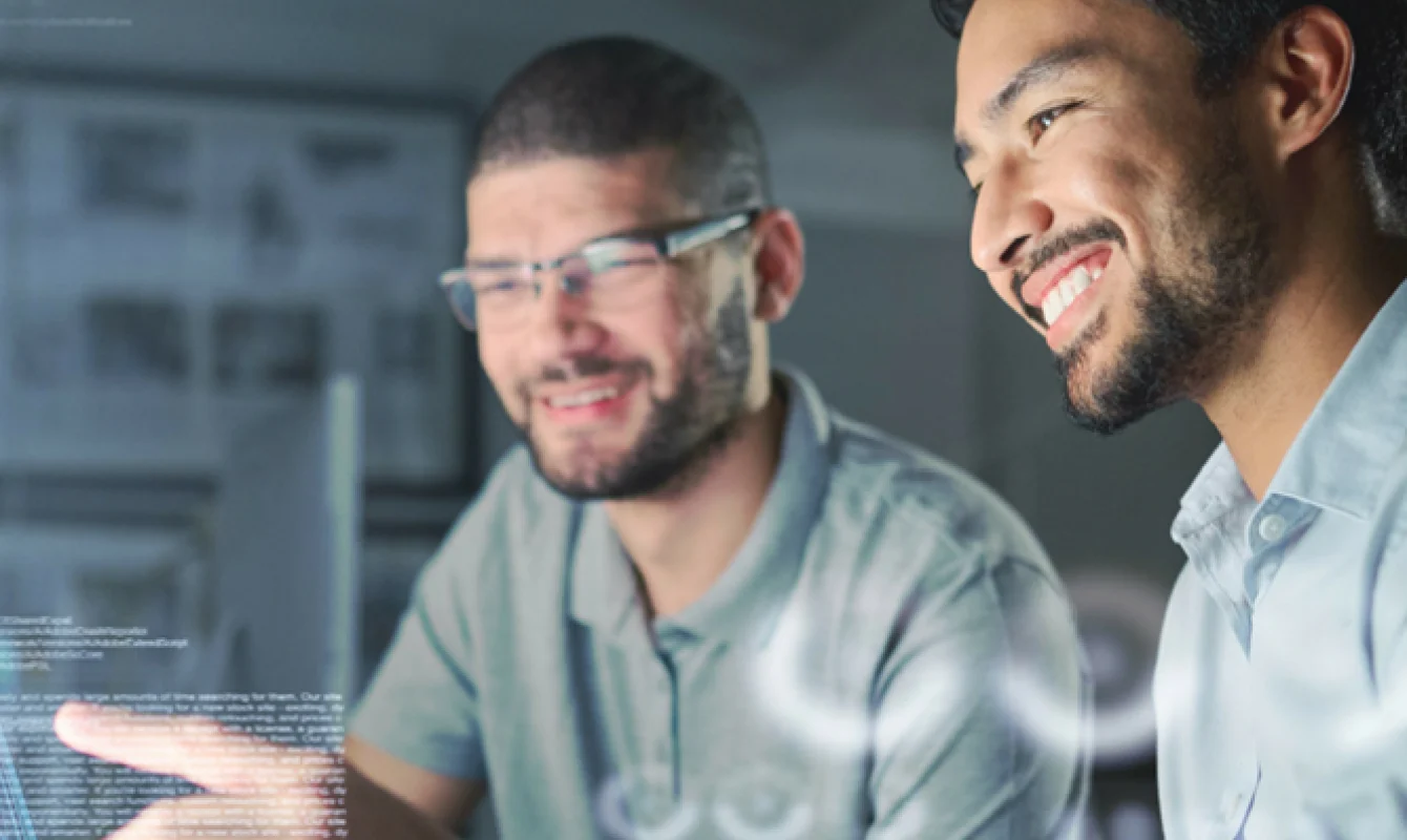 Two men collaborating at a desktop computer