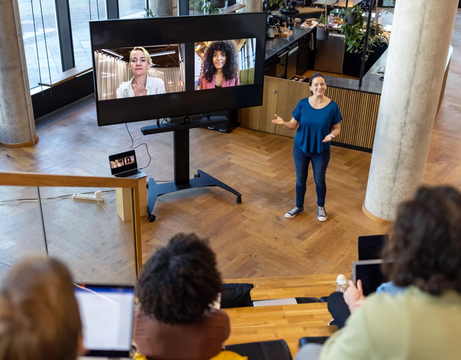 A professional woman presenting in an office.