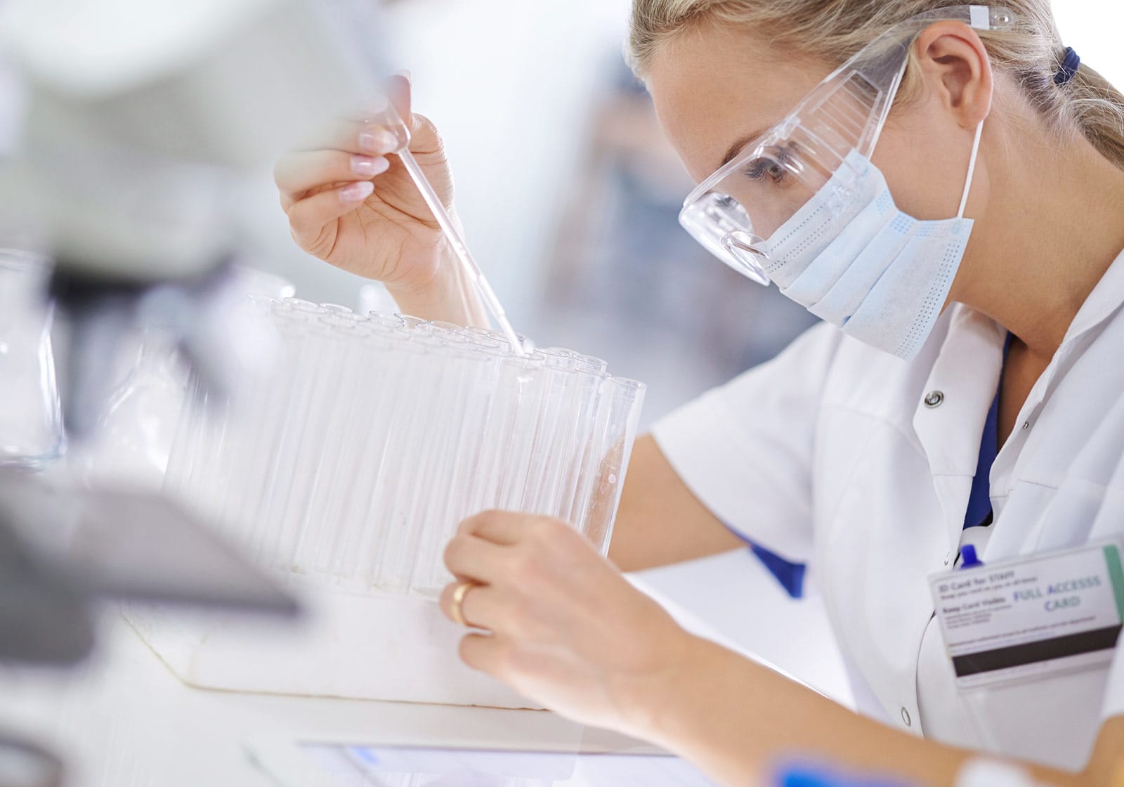 A scientist filling test tubes