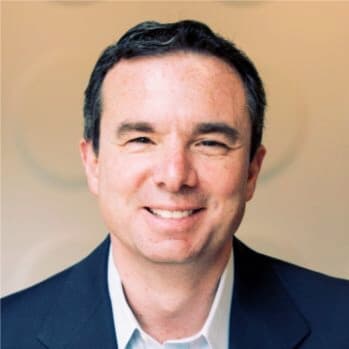 Headshot of blog author Mike Capone, CEO of Qlik. He is wearing a dark suit jacket and light-colored shirt, smiling with a neutral background.