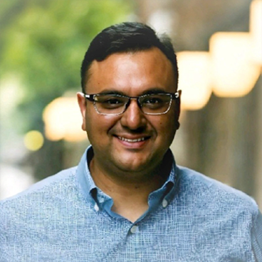 headshot of male on coral circle background