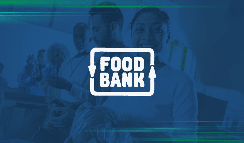 A background of a woman is giving out food to individuals at a food bank with a blue overlay features the Foodbank Victoria logo in white in the center.