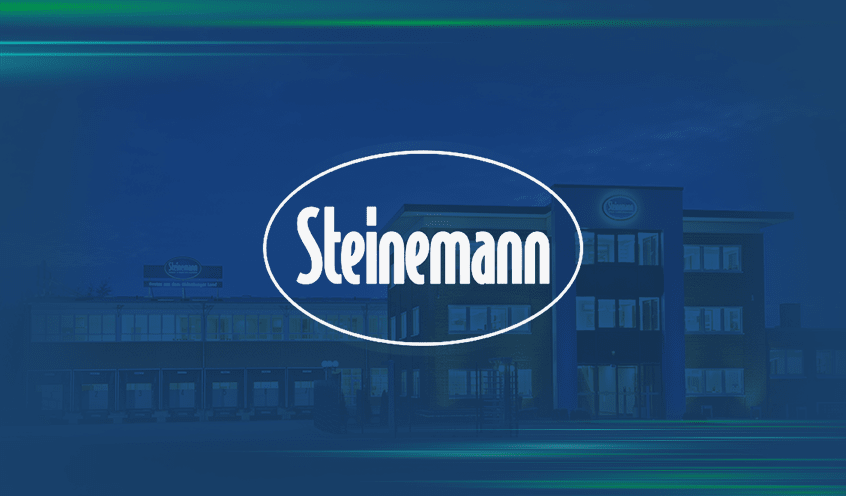 A Steinemann building illuminated against a clear blue sky at night with a blue overlay features the Steinemann logo in white at the center.