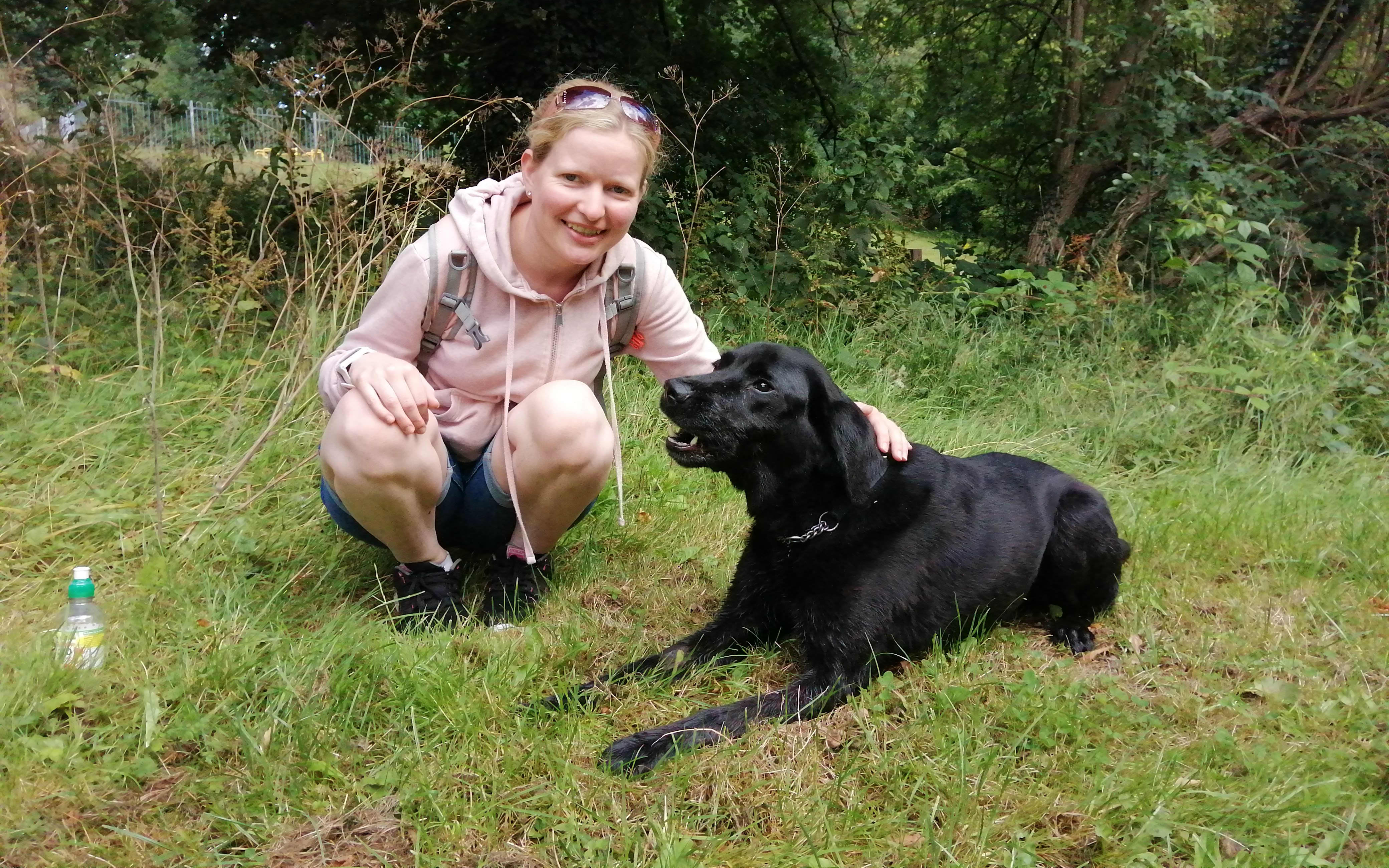 Photograph of tal's pals owner Chantal with a black labrador.