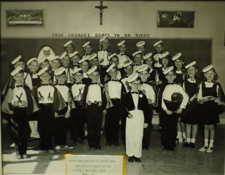 Christ the King School Rhythm Band 1959 Back row (l-r): Sister Henrietta, Doris Cranston (nee Gosselin) (triangles), David McDonald (triangles), Gary Chrusch (triangles), Clarence Bauer (triangles), Alan Phalen (triangles), Gary Sutter (triangles) Middle row(l-r): Ronald Ruetz (rhythm sticks), Patricia McDonald (rhythm sticks), Beverly Erick (rhythm sticks), Gregory Beeson (rhythm sticks), Roger Voll (rhythm sticks), David Girodat (rhythm sticks), Gerald Fritz (sand blocks & bells), Dwayne Lingenfelter (cymbals), Alan Ruetz (cymbals), Janet Nelson (tambourines), Teresa Wilson (tambourines), Pauline Chrusch (tambourines), Sandra Scribner (tambourines), Doreen Chrusch (tambourines) Front row (l-r): Dennis Jodoin (rhythm sticks), Kenneth Carson (rhythm sticks), Paul Gosselin (rhythm sticks), Richard Ruetz (rhythm sticks), Mark Audette (tone block), Gary Carson (Split Bamboo Sticks), Brian Kiss (cymbals), David Houston (drums & bells), Dennis Poulin (drums & bells) Conductor: Terry Madden
