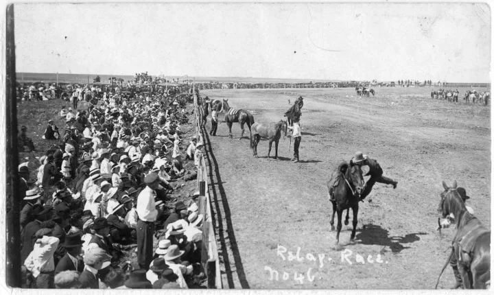 This photograph of the relay race event at Shaunavon's 1914 Frontier Day Stampede shows the large crowd that flocked to the community to enjoy the festivities.