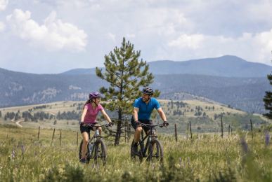Father and daughter mountain biking on Angel Fire trails