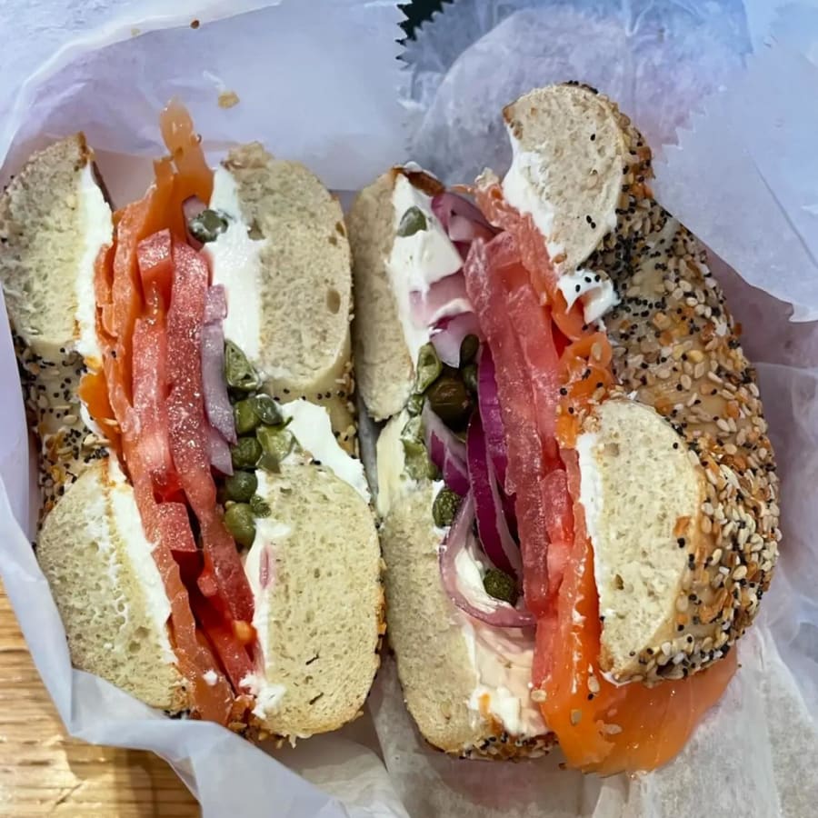 An everything bagel built with cream cheese, lox, tomato, red onion and capers