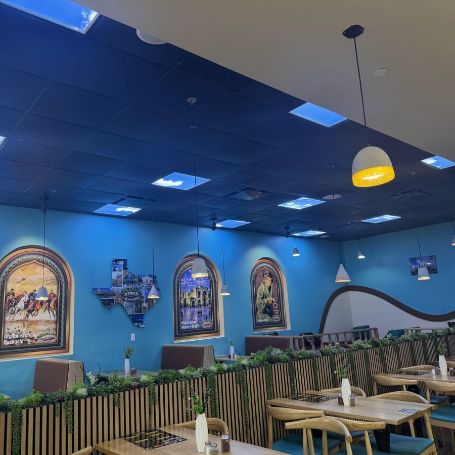 The Zamzam Kabab dining room, teal walls and wood tables
