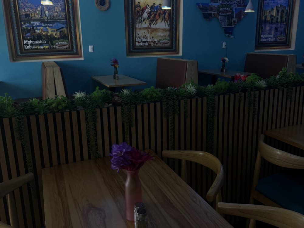 Tables set along the mural wall at Zamzam Kabab