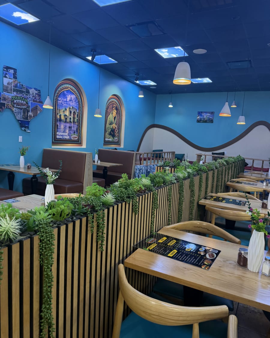 A table for two beside the wood screen and planters