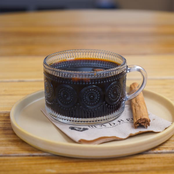 Café de olla in a glass mug with a cinnamon stick
