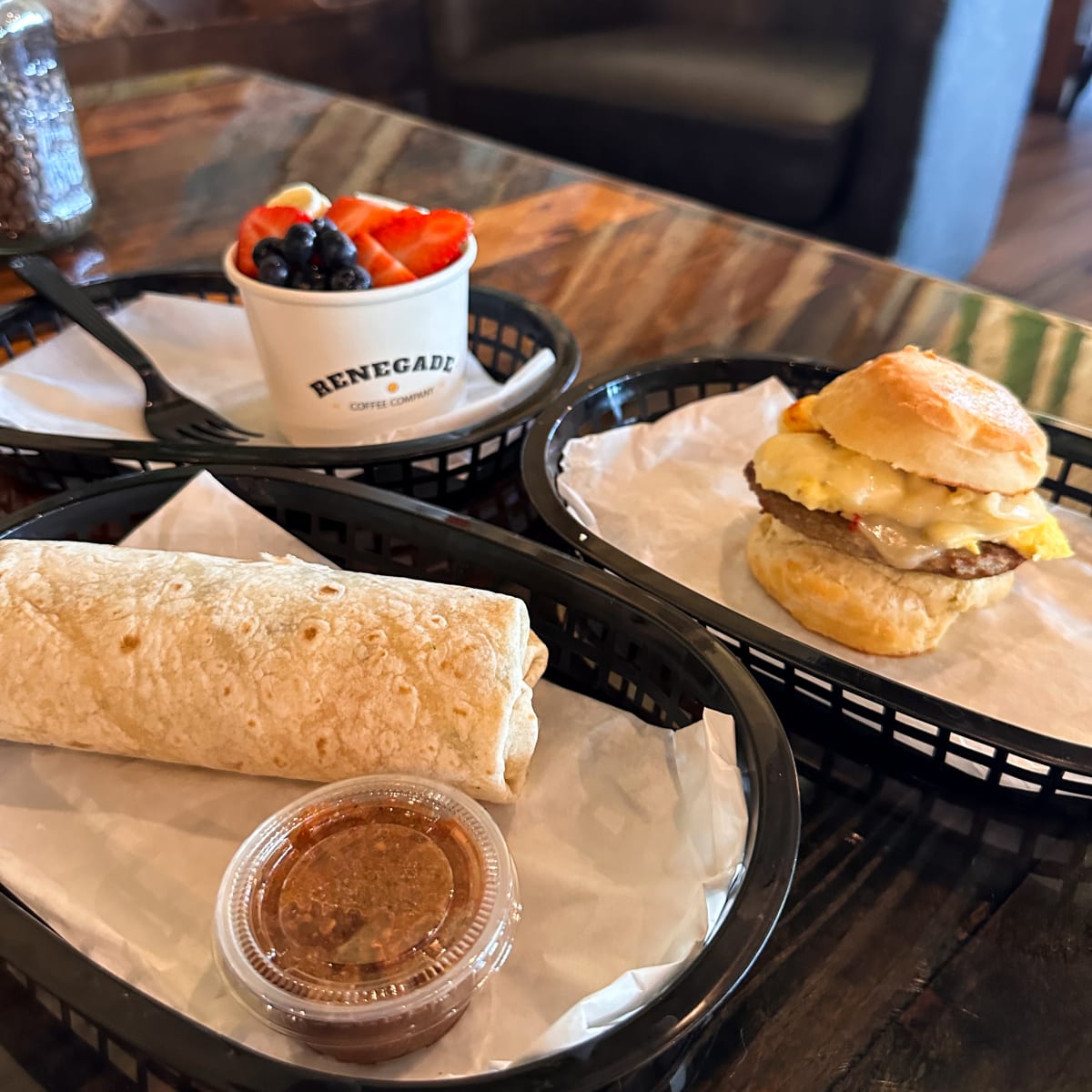 A breakfast burrito, a breakfast sandwich and a fruit cup made fresh at Renegade