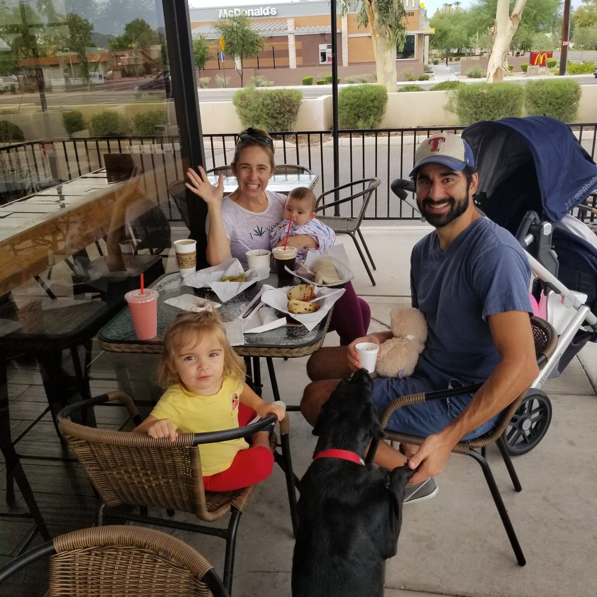 A family and their dog enjoying drinks on the Renegade patio
