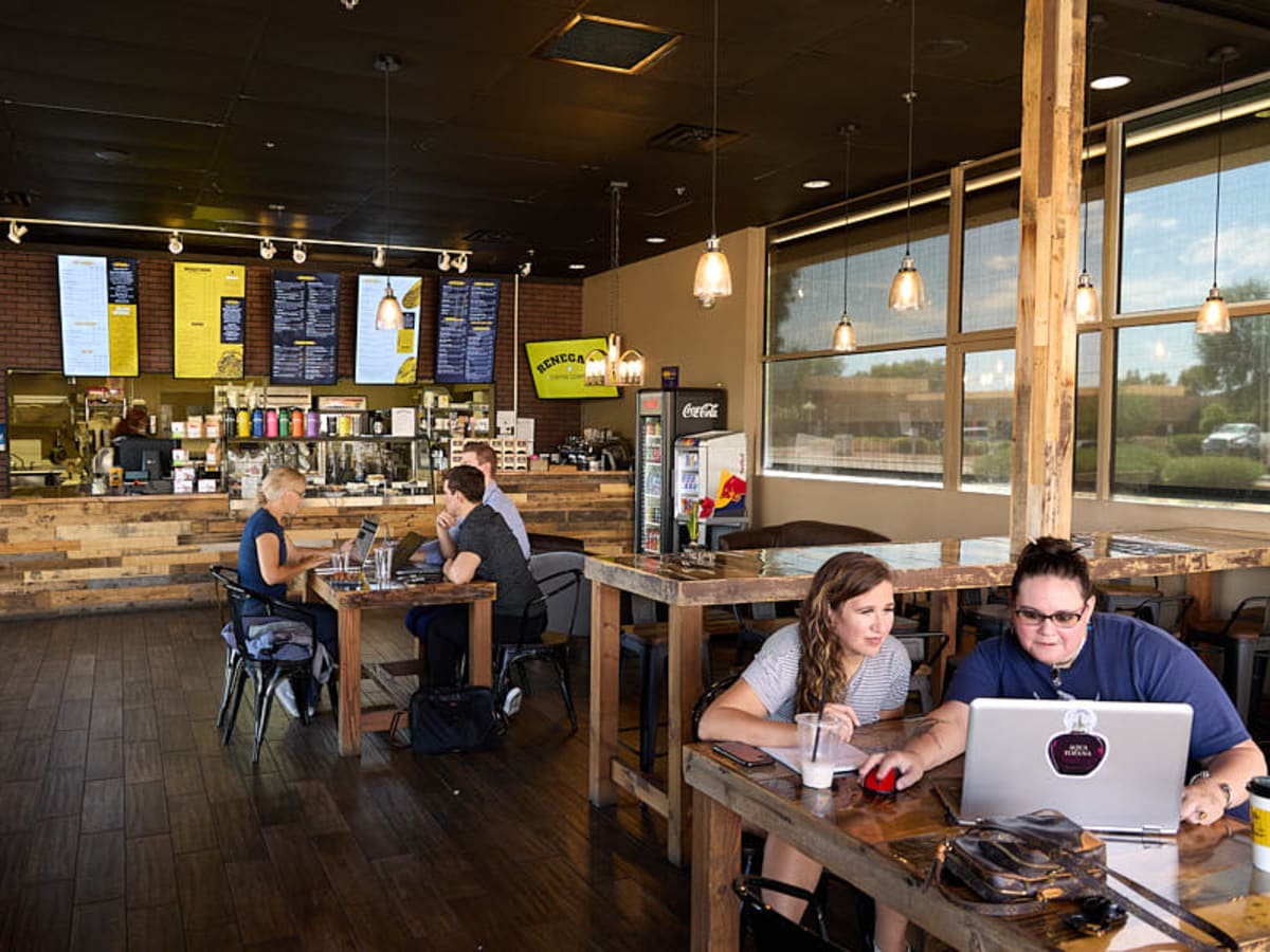 A guest working on a laptop in the Renegade dining room