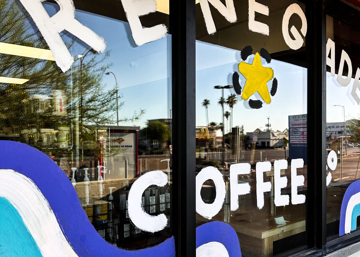 The hand-painted Renegade star and COFFEE lettering on the shop window