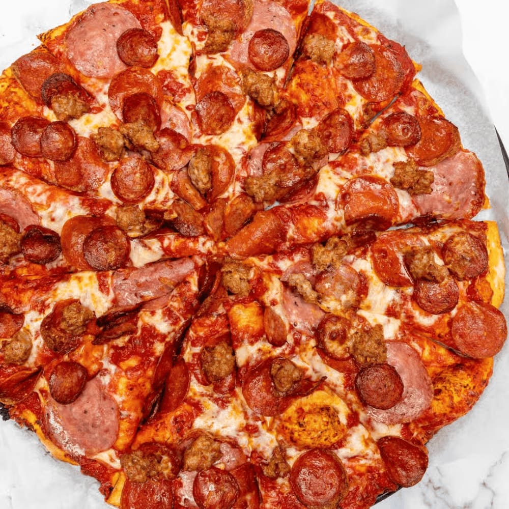 Pizza topped with pepperoni, salami and sausage