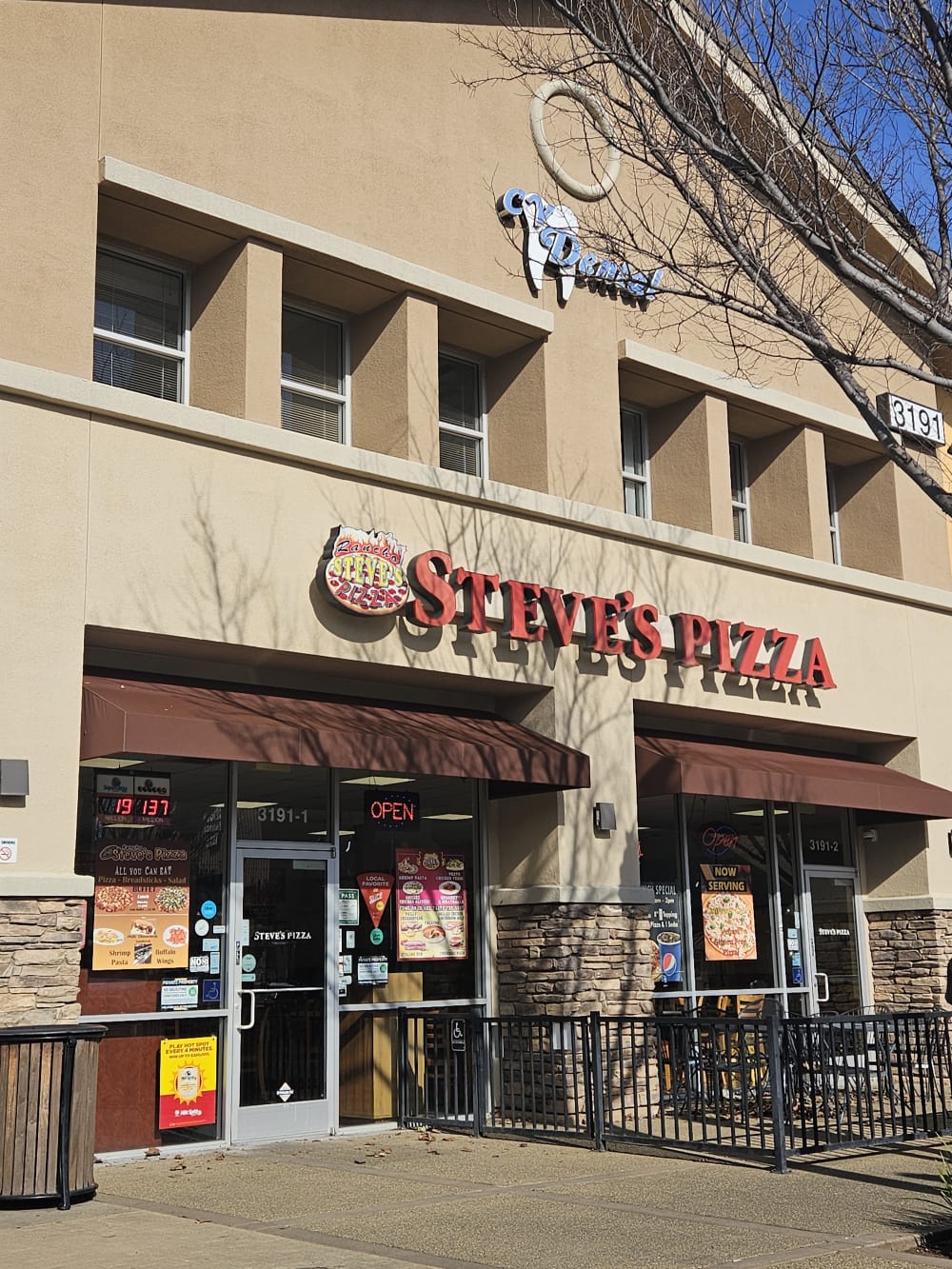 Front entrance of Rancho Steve's Pizza in Rancho Cordova beneath the red Steve's Pizza sign