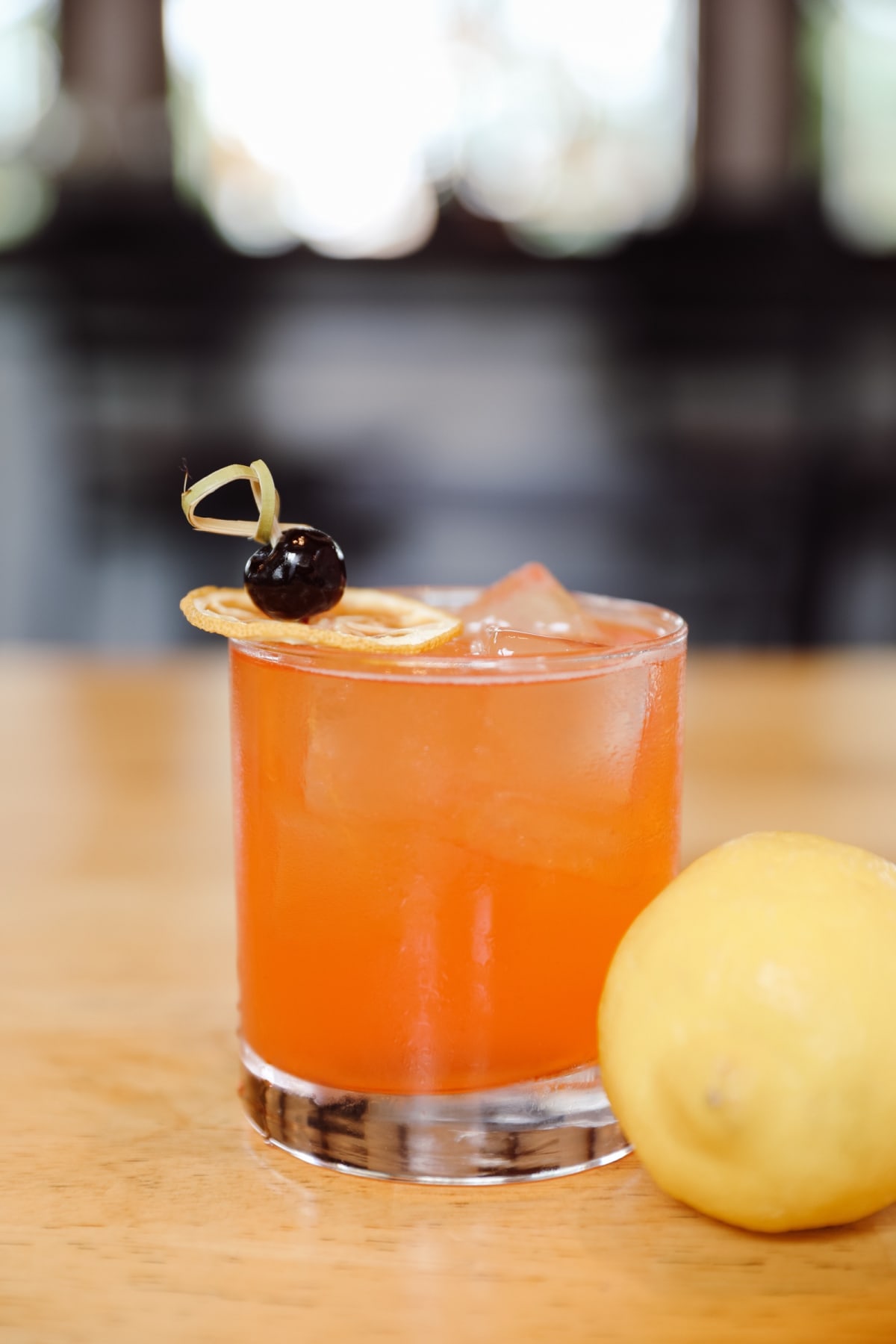 Craft cocktail with lemon and amarena cherry
