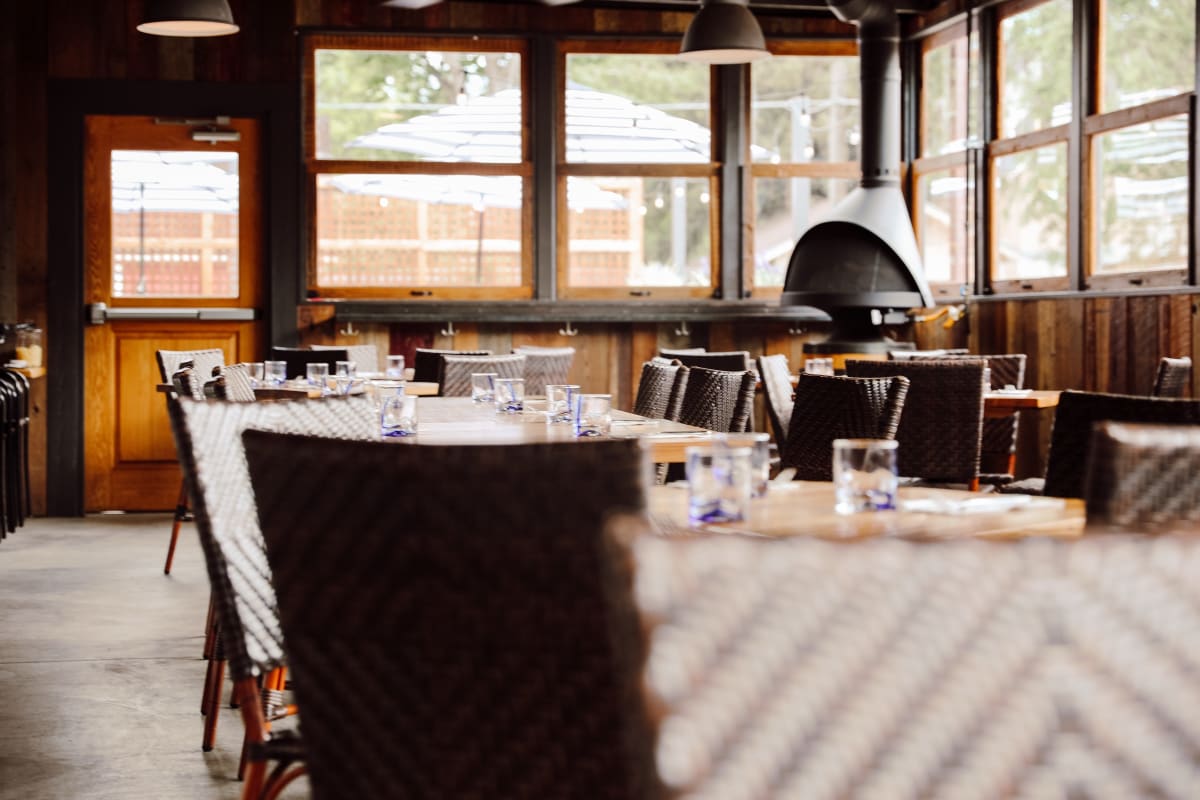 The Sunshine Room set for dinner, wood-fired oven behind