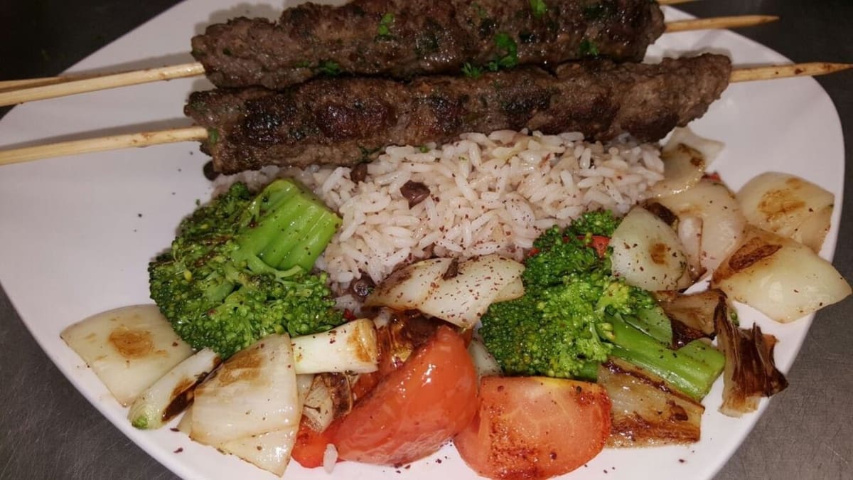 A grilled kabob platter at Petra with rice and grilled vegetables