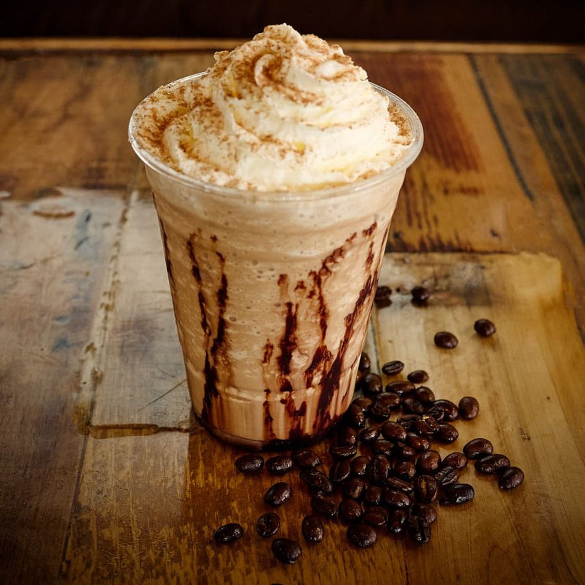 A blended mocha topped with whipped cream and chocolate drizzle