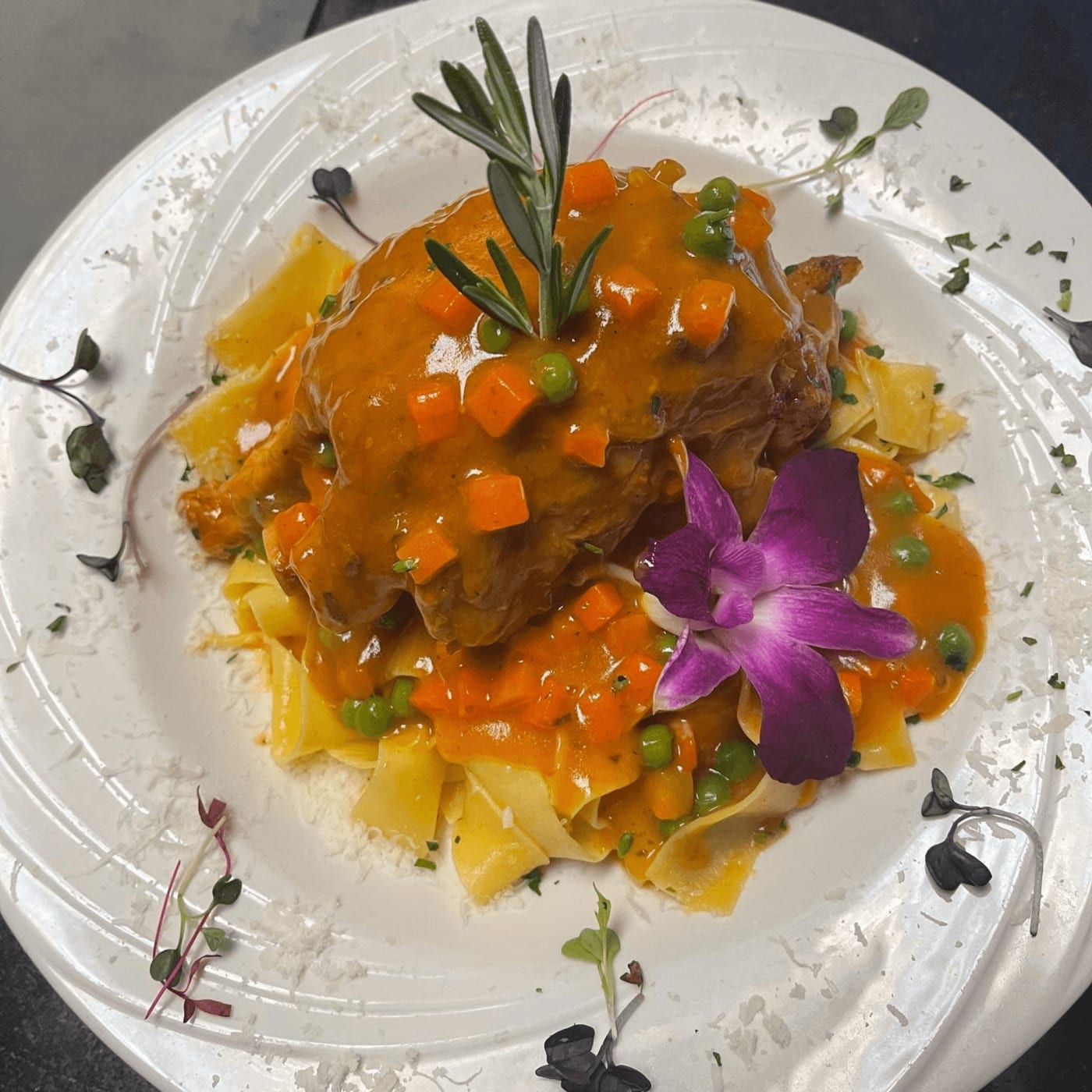 Osso buco over pappardelle with carrots, peas and rosemary