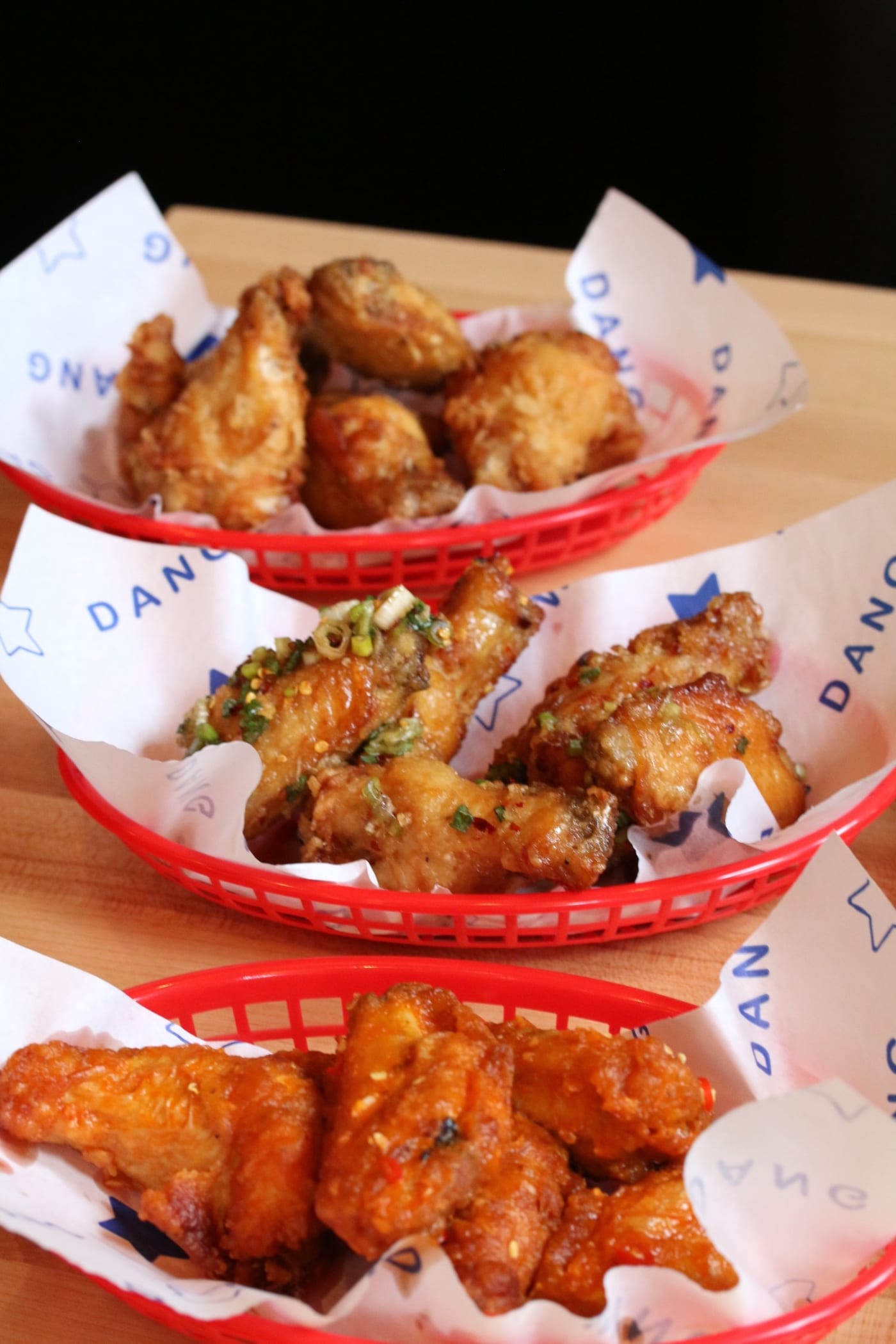 Three baskets of Dang Good Wings in their three sauces