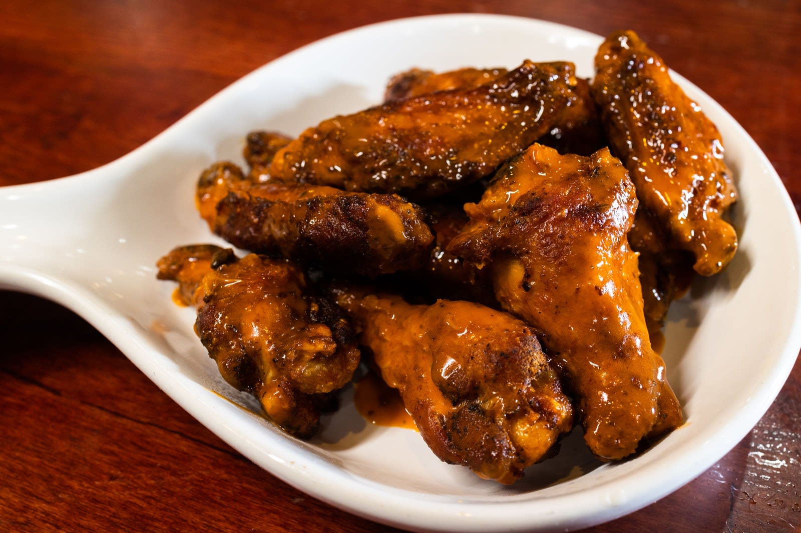 BBQ wings in a white serving dish