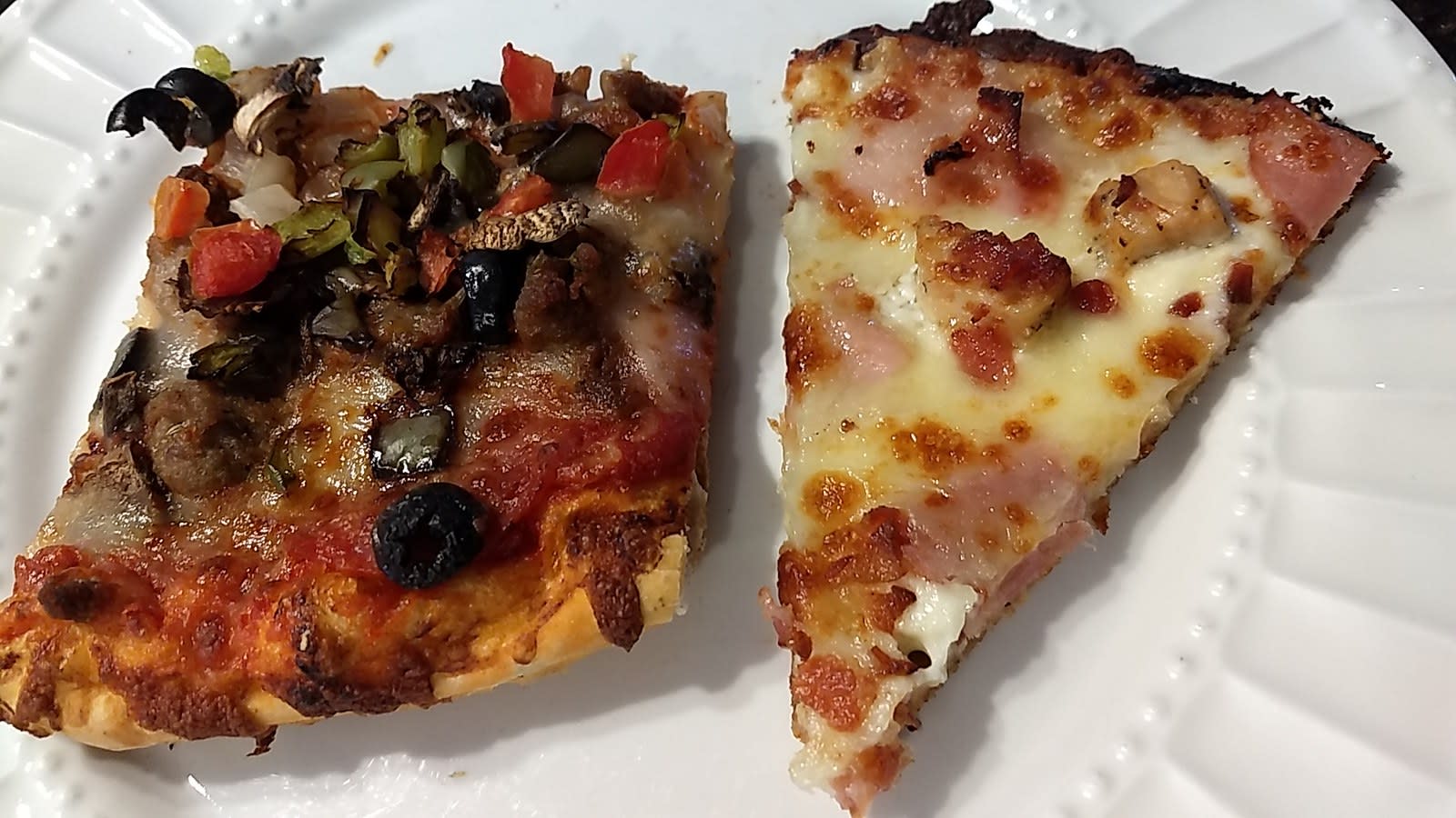 Two slices of Boss' pizza on a plate