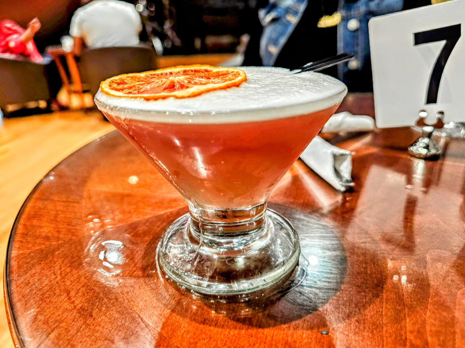 A cocktail finished with a dried orange wheel