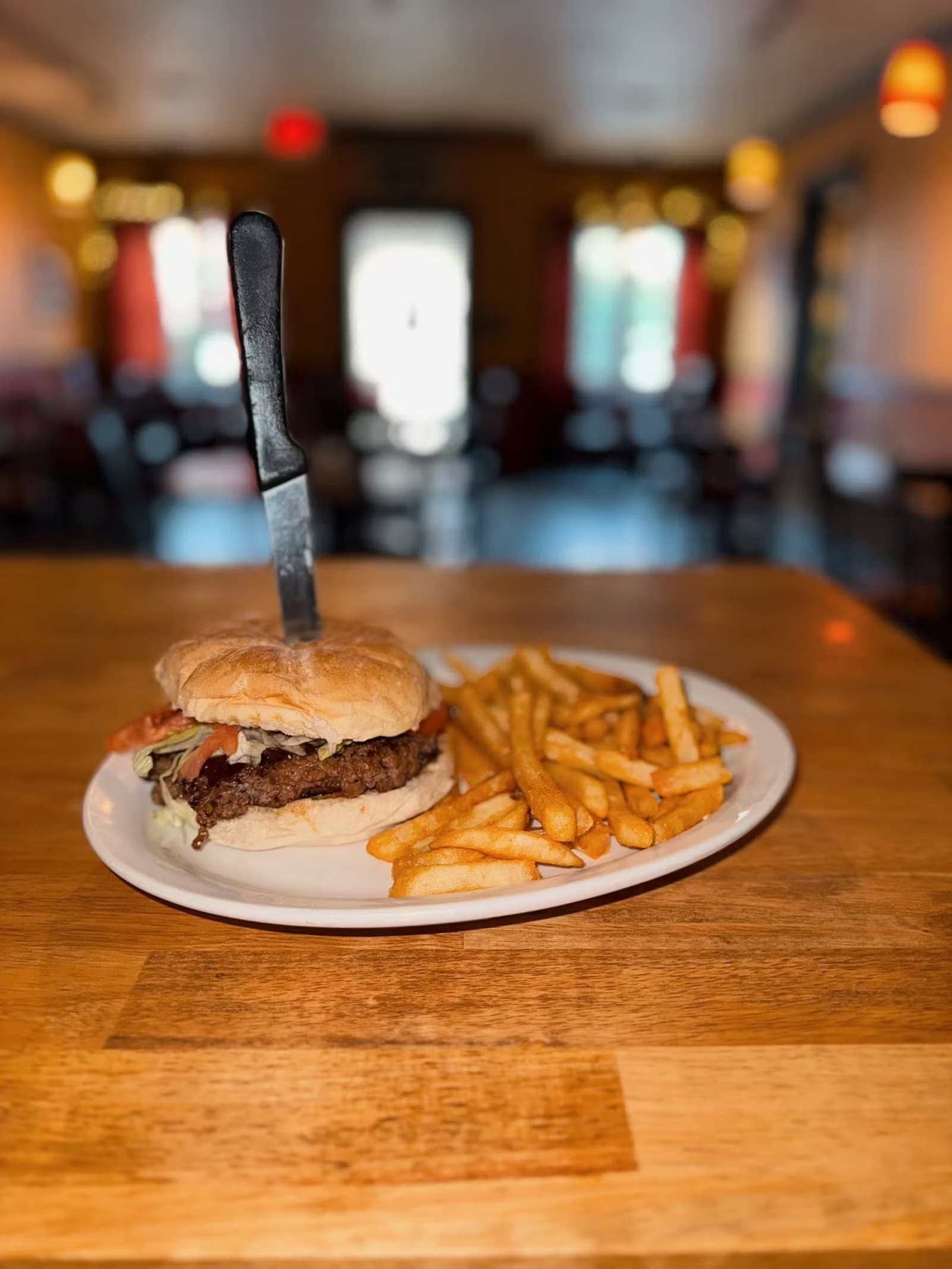 A half pound Angus burger and fries in the dining room