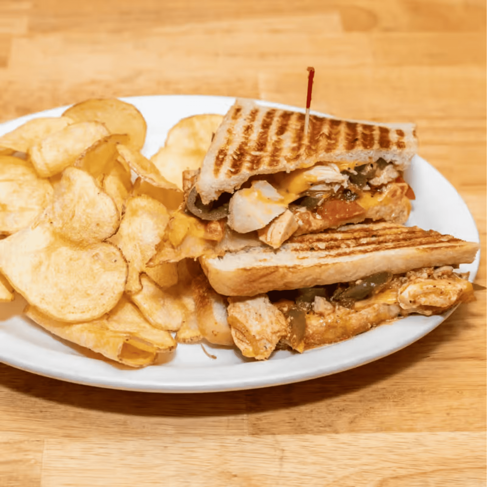 A grilled chicken panini with house made chips