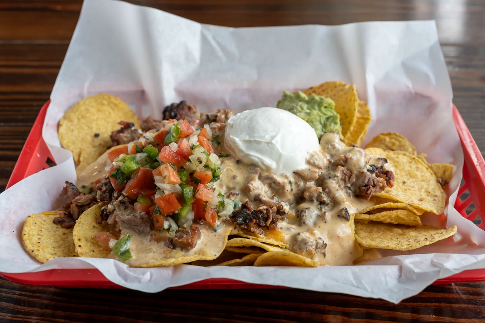 Brisket nachos with pico de gallo, sour cream and queso