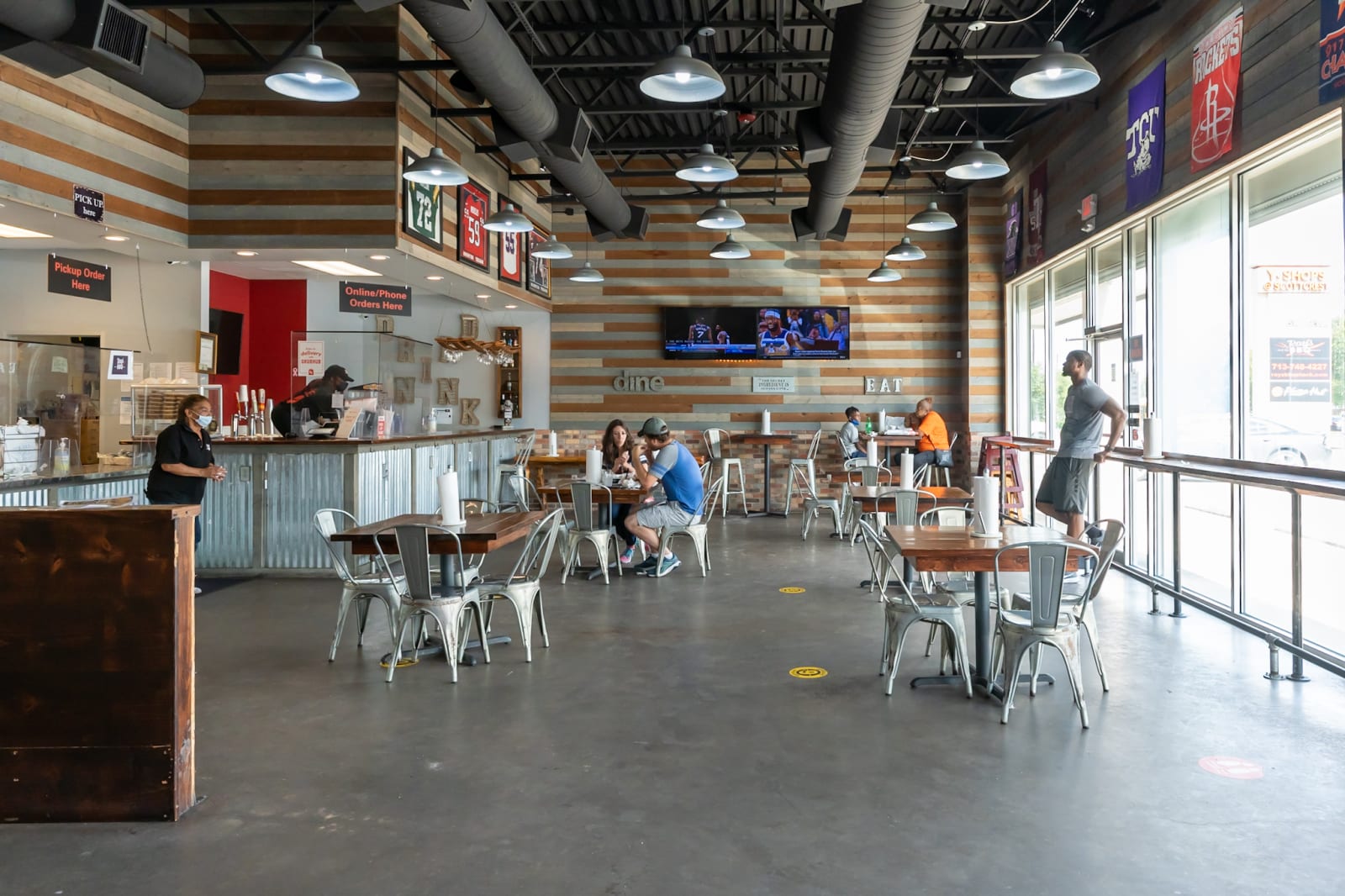 The dining room at Ray's with wood tables and counter seating