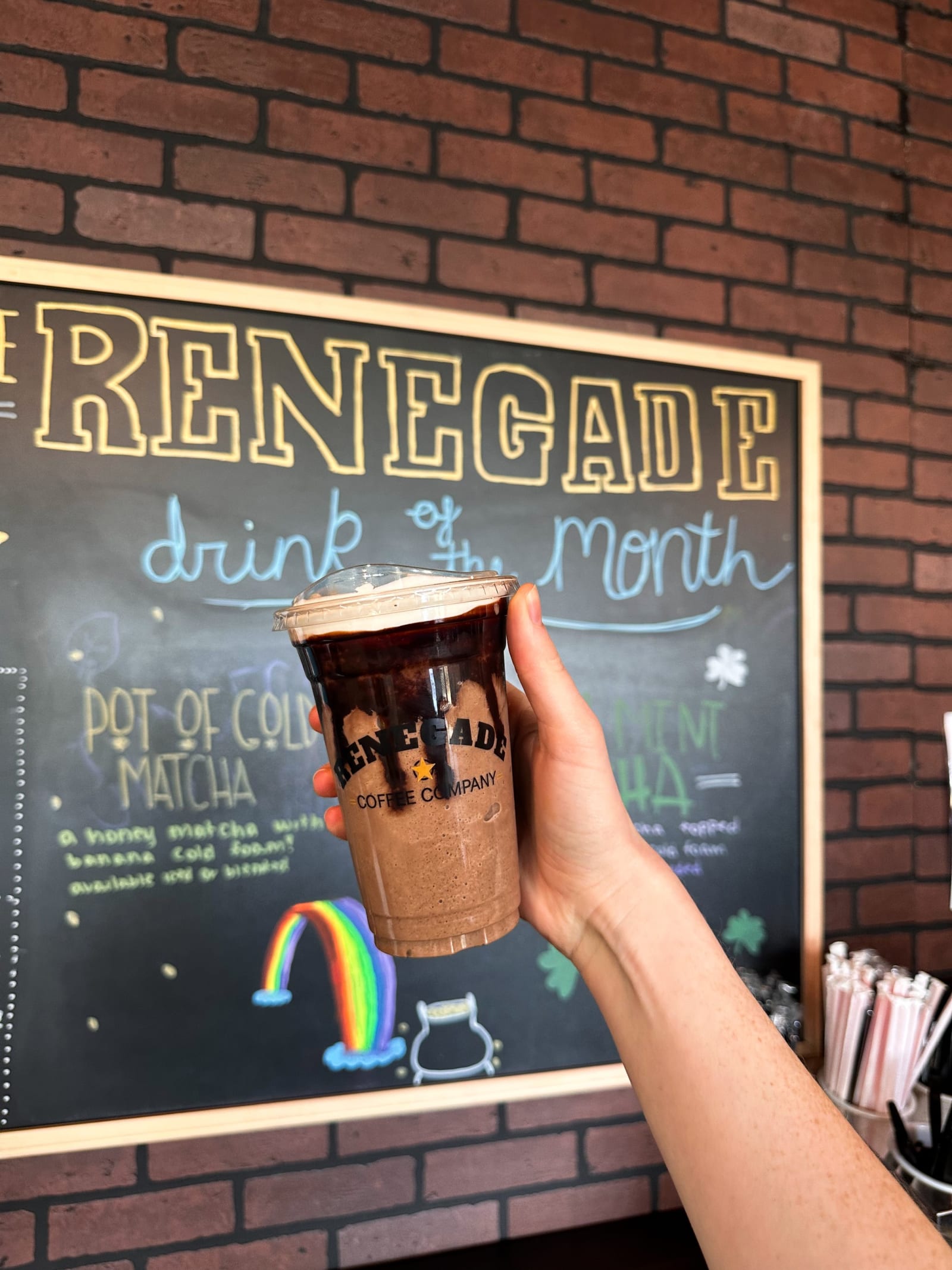 The hand-lettered Drink of the Month chalkboard at Renegade Coffee