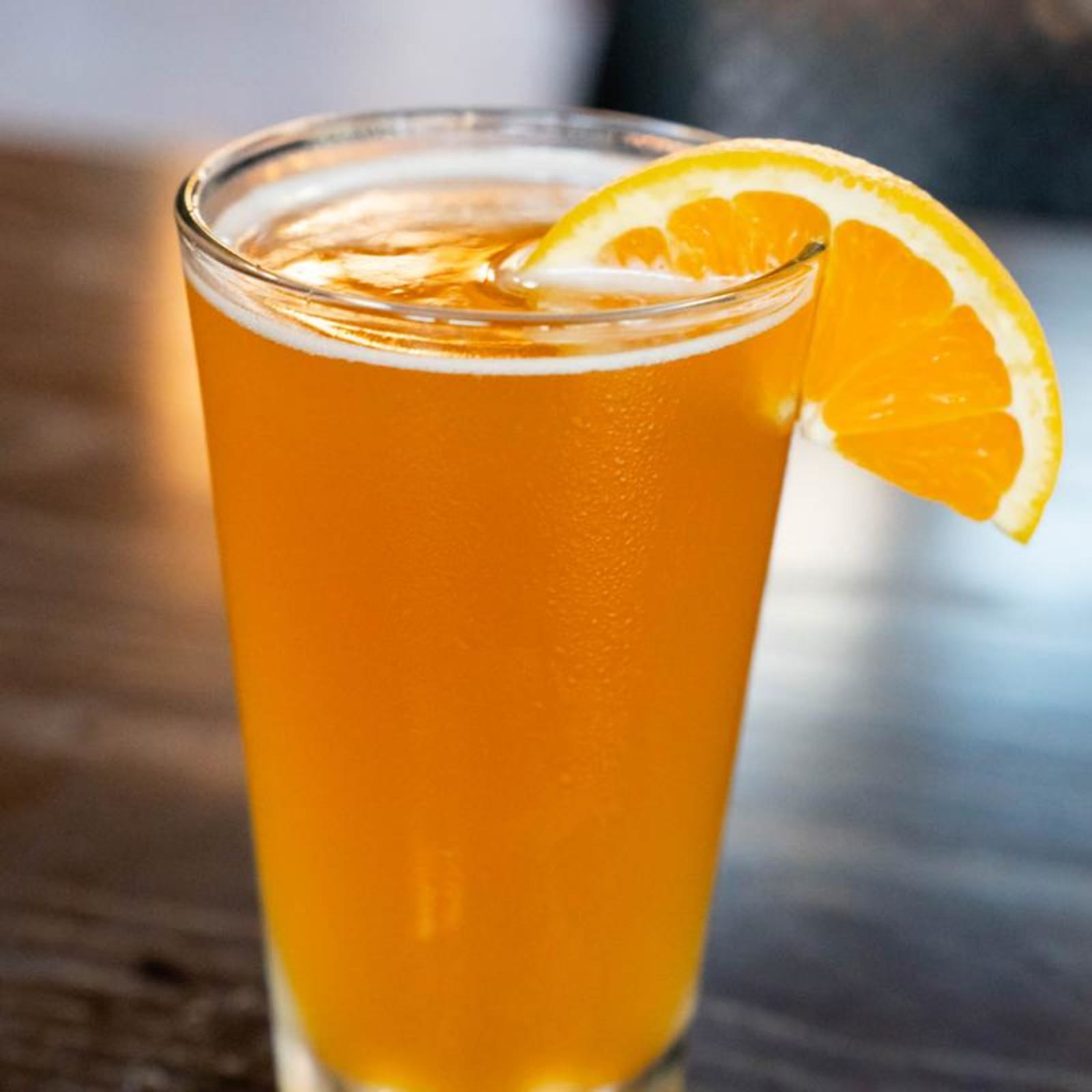 A draft beer with an orange slice