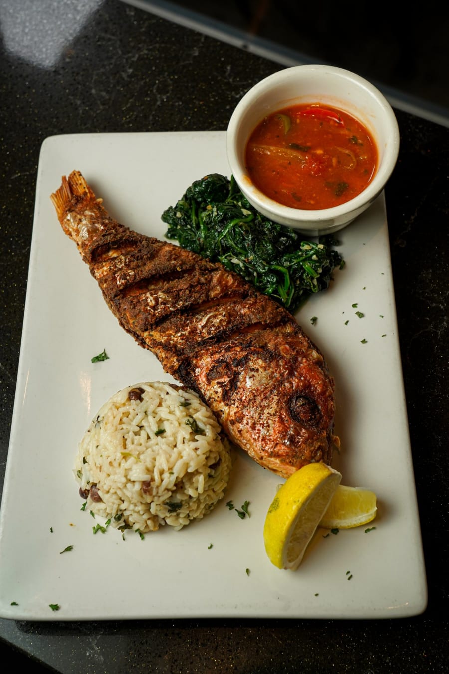 Whole grilled red snapper with rice and greens